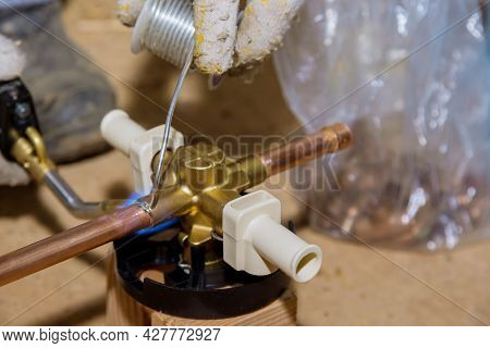 Blue Flame Torch Soldering A Brass Diverter For Shower Bathtub On Water System.