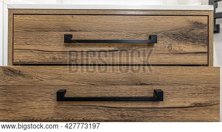 Wooden Chest Of With Drawers With Black Handles Close Up.