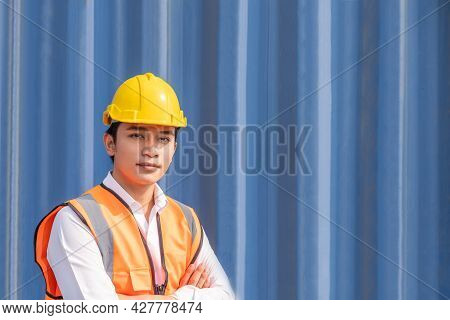 Asian Men Freight  Worker Wearing Safety Vest And Hat While Inspect Condition Of All Containers Ship
