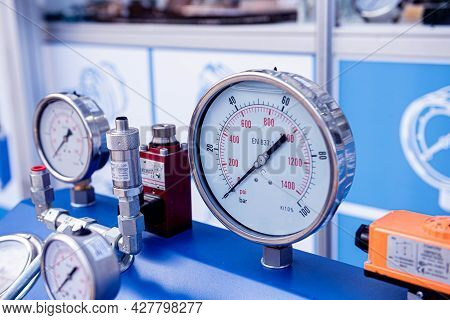 Monometers Of Different Sizes On A Light Background