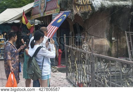 August 21, 2017. Gombak, Malaysia.  A Group Of Tourists Taking A Picture Of A Long Tailed Macaque Si