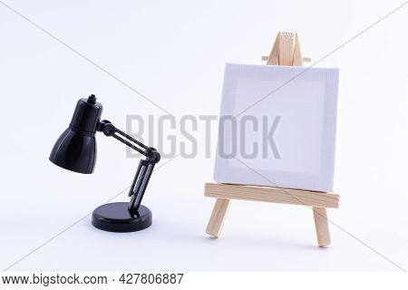 Wooden Easel Miniature With Blank White Square Canvas For Artists And Painters - Mockup. Mini Wooden