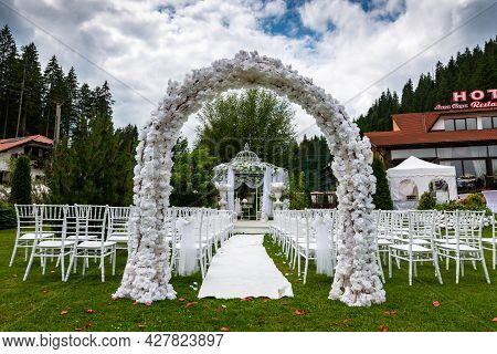 Lacu Rosu, Romania- 25 July 2021: White Wedding Arch At Local Hotels Garden.