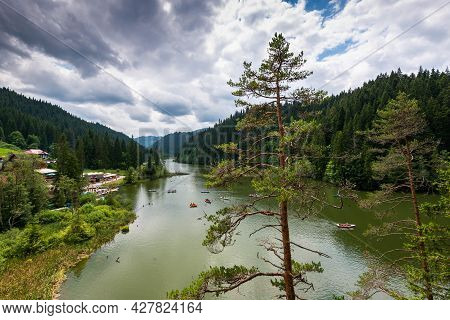 Lacu Rosu, Romania- 25 July 2021: People Spending The Summer Holiday Boating On The Unique Lake.