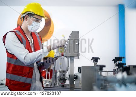 Quality Control (qc) Engineer Monitoring And Checking Machine System In Manufacturing Factory
