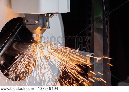 Automatic Cnc Laser Cutting Machine Working With Cylindrical Metal Workpiece With Sparks At Factory,