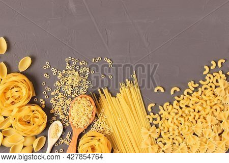 Different Types Of Pasta Close-up On A Colored Background.
