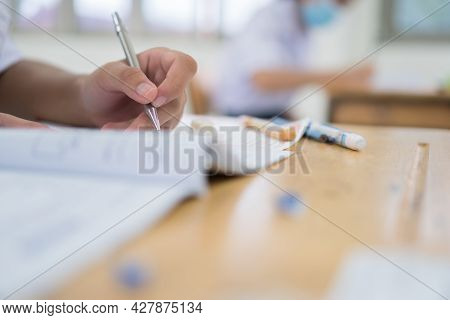 Asian Hands Student Testing In Exam On Exercise Taking At High School Or University In Test Room. Wr