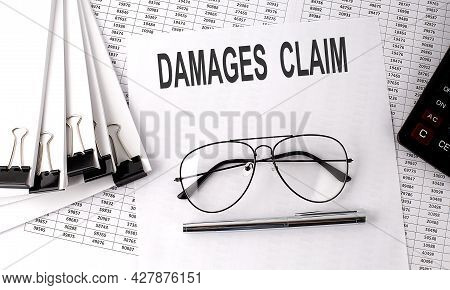 Demages Claim Text On Paper With Chart And Office Tools , Business