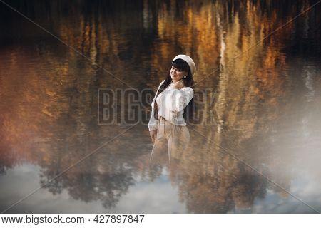 Picture Of Attractive Woman Goes For A Walk Near The River, Rejoices And Enjoys Of Her Llife