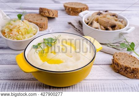 Mashed Potatoes With Butter, Fried Mushrooms With Onions And Salad Of Fresh Vegetables On Light Wood