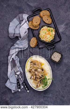 Mashed Potatoes With Butter, Fried Mushrooms With Onions And Salad Of Fresh Vegetables On A Gray Cem