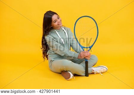 Cheerful Teen Girl In Sportswear Hold Tennis Racquet On Yellow Background, Sport