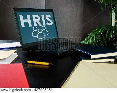 Open Laptop With Hris Human Resource Management System.