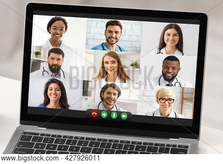 Laptop With Group Video Call Of Doctors Standing In Office