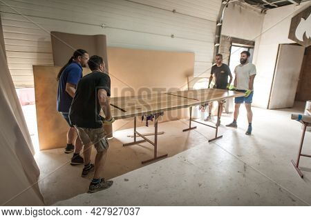 Team Of Carpenters Making Furniture In A Workshop. Woodworking And Crafts Tools