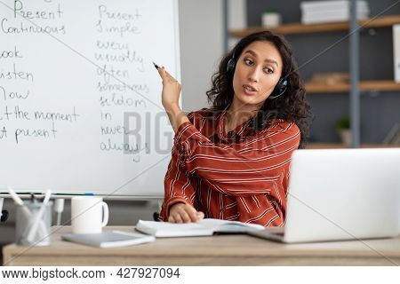 English Teacher Pointing On Board, Videochatting With Sudents Online