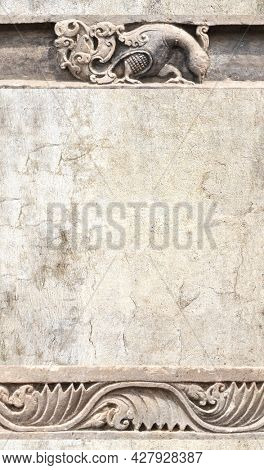 Ancient stone ornament with flower and peacock. Vertical background with decorative bird pattern and floral bas-relief. Mock up template. Copy space for text