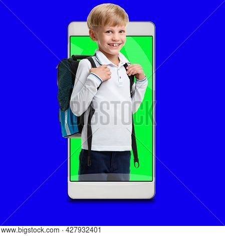 Young Smiling Schoolboy Using Modile Application For Remote Study Concept, Blue Chroma Key On The Ba