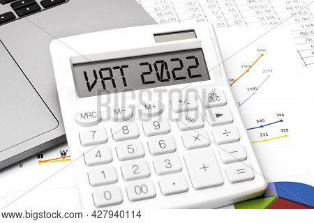 Text Vat 2022 - Value - Added Tax On Calculator, Laptop, Chatrs, Graphs. Business Flat Lay.