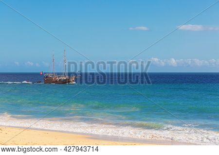 Pleasure tourist ship near the famous beach of Praia dos Caneiros. Algarve.Portugal