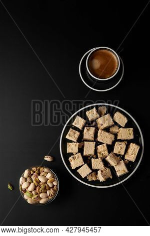 Halva With Pistachios Served With Coffee On Black. Traditional Middle Eastern Sweets. Jewish, Turkis