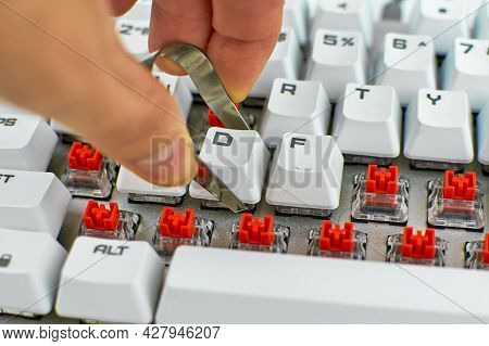Person Cleans A Computer Keyboard. Cleaning Of Computer Equipment. Dusty Mechanical Keyboard. Mechan