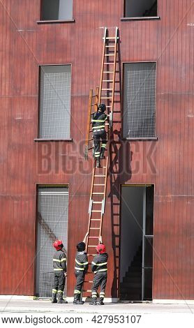 Fire Brigade Team Performing An Exercise In Using The Stairs To Reach The Upper Floors Of The House 