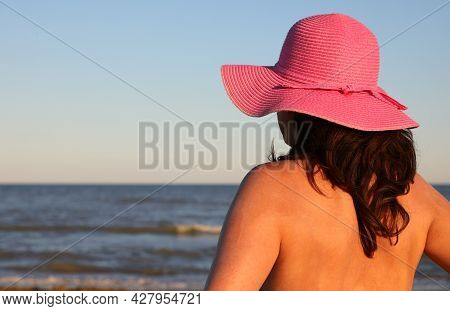 Young Tanned Woman In Straw Hat With Long Hair And Seashore In Summer
