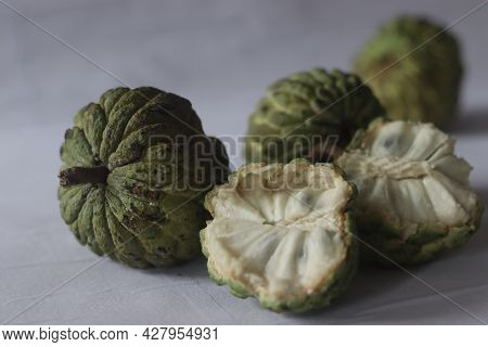 Custard Apple. A Cherimoya Family Fruit With Green And Leathery Skin. It Has White Creamy And Sweet 