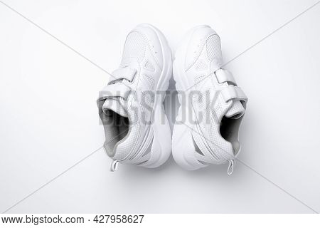 Top View Of A Set Up Of Childrens White Sneakers Standing In A Pyramid Or House Isolated On A White 