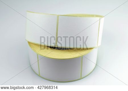 Babina Of Self-adhesive Stickers On A White Background. Self-adhesive White Label Roller For Printin