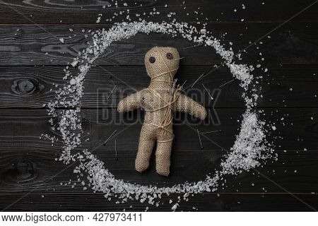 Voodoo Doll And Pins In Salt Circle On Black Wooden Table, Flat Lay