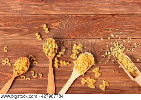 Different Types Of Raw Pasta Close-up On A Colored Background.