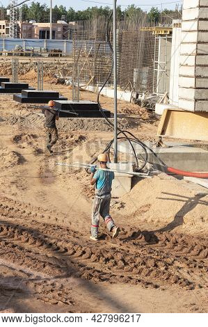 A Worker Transfers Elements For The Installation Of The Formwork At The Construction Site. Monolithi