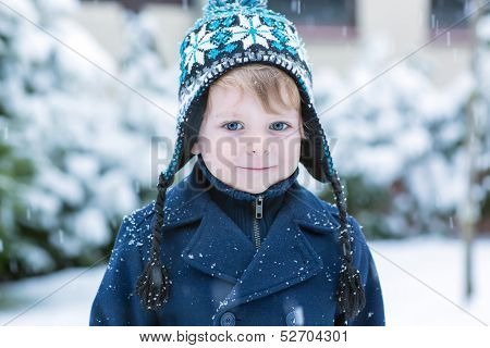Little Toddler Boy Having Fun With Snow Outdoors On Beautiful Winter Day.