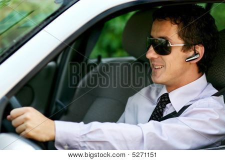 Businessman Driving In The Car With Bluetooth, Handsfree