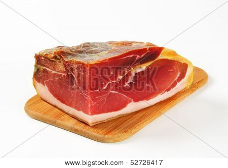 whole block of parma ham, served on a wooden cutting board