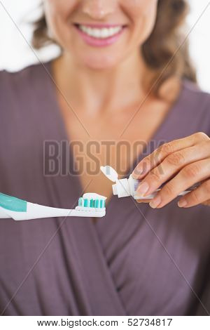 Closeup On Young Woman Squeezing Toothpaste From Tube