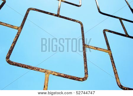 Angled Abstract Closeup View Of Metal Gate On Sky
