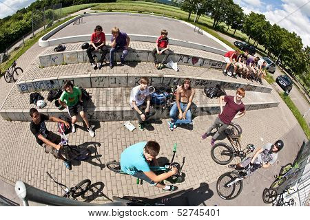 Boys At A Skate Park Watching Other Bikers And Having Fun