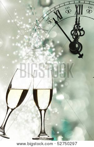 Glasses with champagne against fireworks and clock close to midnight 