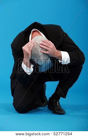 Businessman holding his head in despair