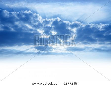Bright sunrays make their way through cumulonimbus clouds, sky background with copy space, beautiful heaven, atmosphere concept