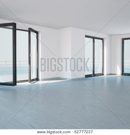 Bright empty room with large windows and a balcony