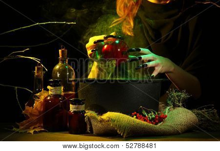  Witch in scary Halloween laboratory on dark color background