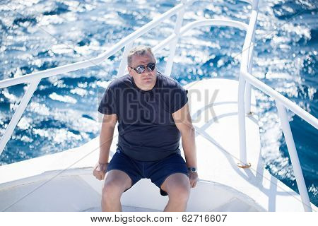 Man sitting on the prow of a boat