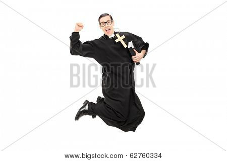 Excited male priest jumping with joy isolated on white background
