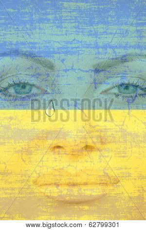 Young Pretty Womans Face With Tear On Ukranian Flag Background.