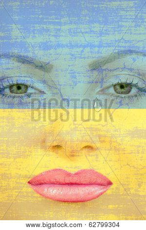 Pretty Womans Face With Tear On Ukranian Flag Background.
